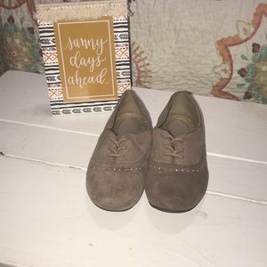 Woman’s tan slip on dress shoes.